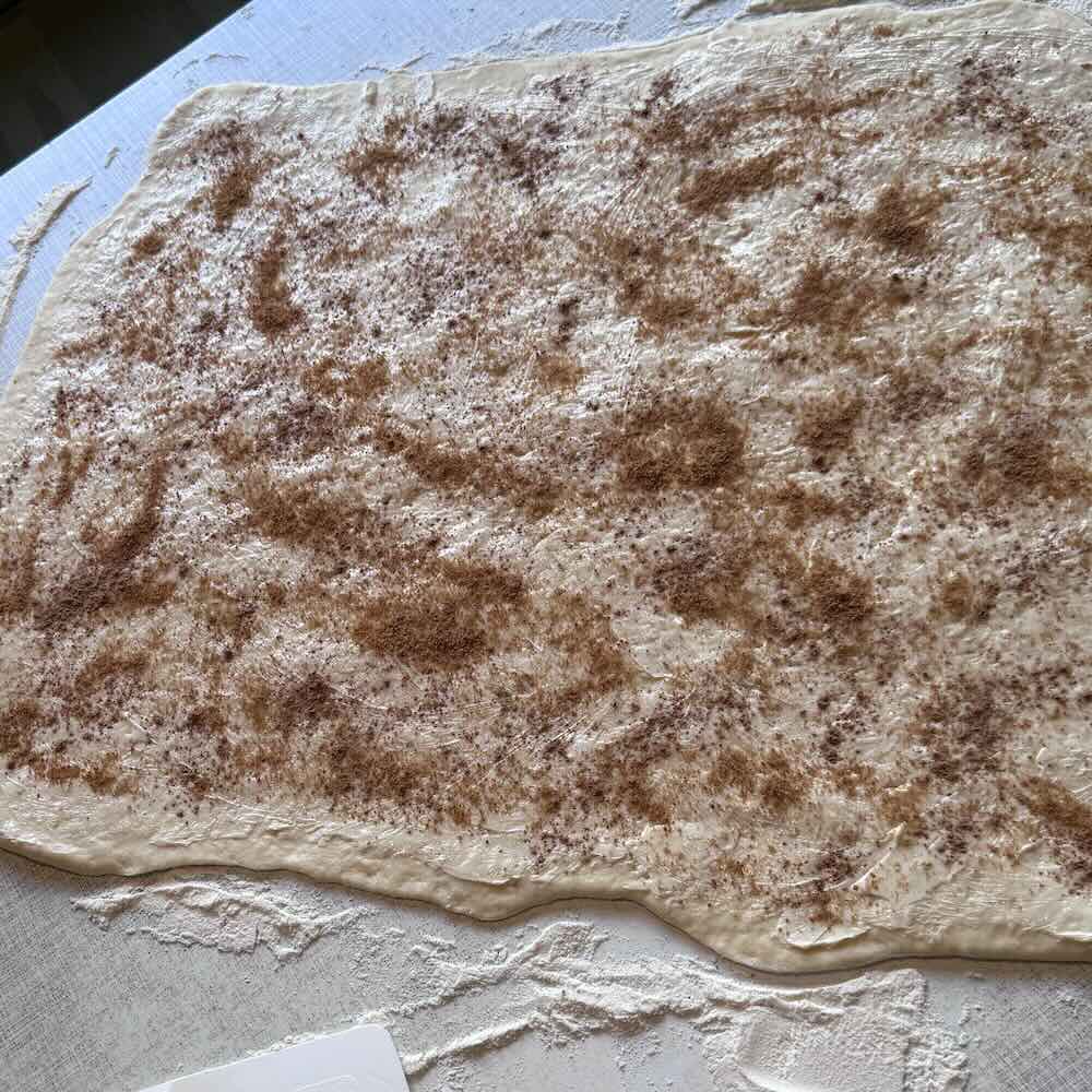Bullar-Teig mit Margarine, Zimt und Zucker bestreut